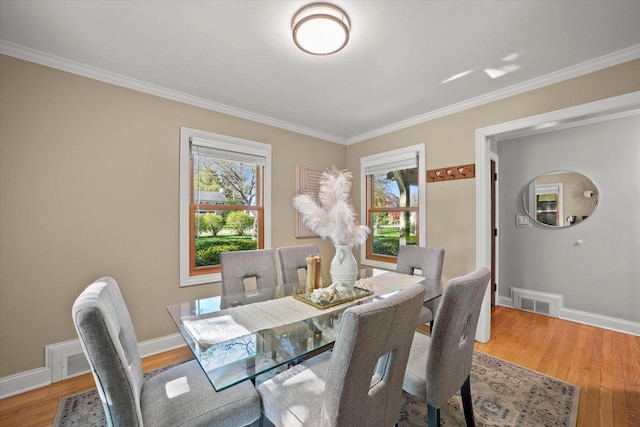 530 W Acacia Rd, Glendale, WI 53217 - dining room featuring plenty of natural light, crown molding, light wood-style flooring, and baseboards