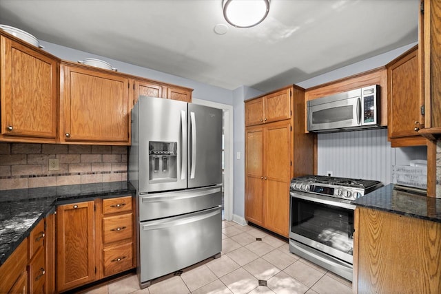 530 W Acacia Rd, Glendale, WI 53217 - kitchen featuring stainless steel appliances, backsplash, dark stone countertops, and brown cabinets