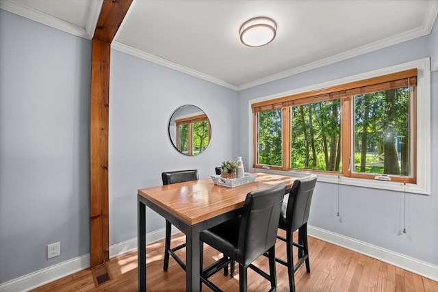 530 W Acacia Rd, Glendale, WI 53217 - dining room featuring baseboards, crown molding, and light wood finished floors
