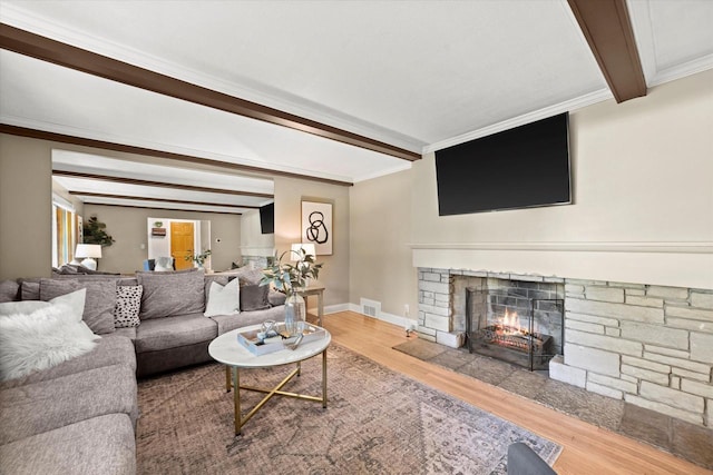530 W Acacia Rd, Glendale, WI 53217 - living room with wood finished floors, beamed ceiling, a fireplace, baseboards, and crown molding
