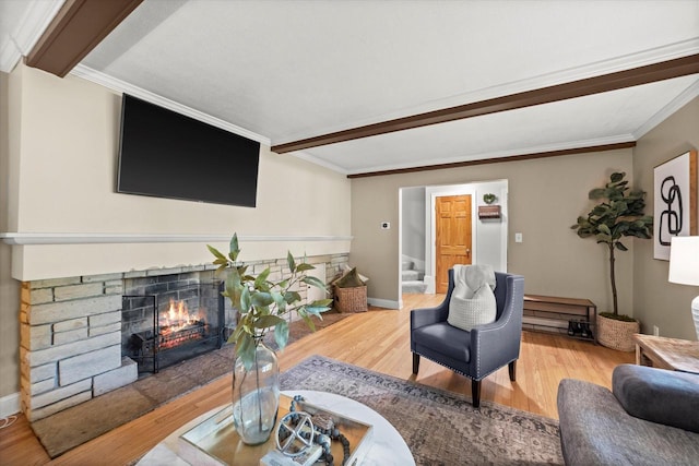 530 W Acacia Rd, Glendale, WI 53217 - living area with wood finished floors, a lit fireplace, beam ceiling, baseboards, and ornamental molding