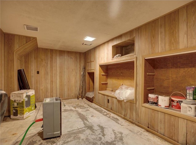 N4190 S County Road P, Spring Valley, WI 54767 - mudroom featuring wood walls, built in shelves, and unfinished concrete floors