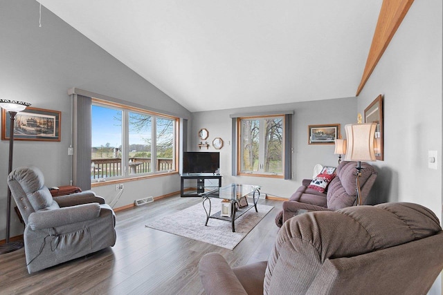 N3351 County Road B, Kewaunee, WI 54216 - living area with lofted ceiling, wood finished floors, and baseboards