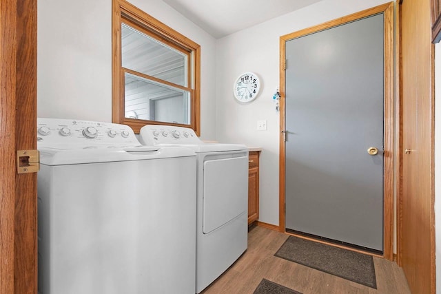 N3351 County Road B, Kewaunee, WI 54216 - laundry area with independent washer and dryer, light wood-style flooring, and cabinet space