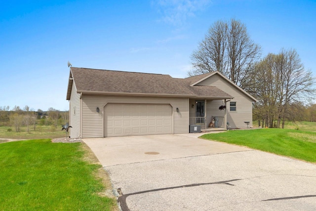 N3351 County Road B, Kewaunee, WI 54216 - view of front facade featuring an attached garage, concrete driveway, a front yard, and a shingled roof