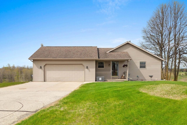 N3351 County Road B, Kewaunee, WI 54216 - view of front of house with an attached garage, concrete driveway, a front lawn, and a shingled roof