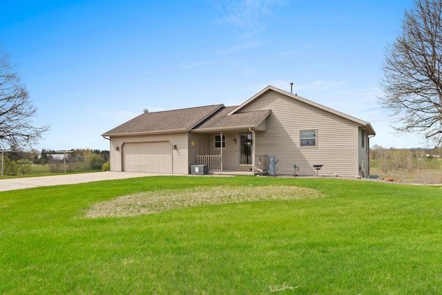 N3351 County Road B, Kewaunee, WI 54216 - view of front of property featuring concrete driveway, central AC unit, an attached garage, a front lawn, and roof with shingles
