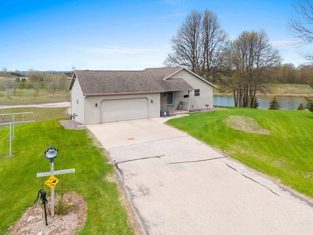 N3351 County Road B, Kewaunee, WI 54216 - view of front of house featuring a garage, a water view, driveway, and a front lawn