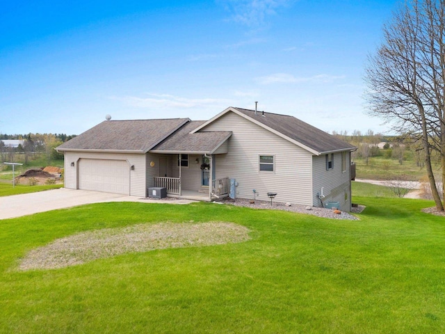 N3351 County Road B, Kewaunee, WI 54216 - view of front of home featuring a garage, a front lawn, driveway, central AC unit, and a shingled roof