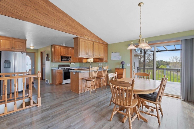 N3351 County Road B, Kewaunee, WI 54216 - dining area featuring wood finished floors and lofted ceiling