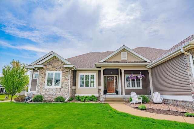 1002 Millies Way, Waunakee, WI 53597 - craftsman house featuring stone siding, a front lawn, and a shingled roof