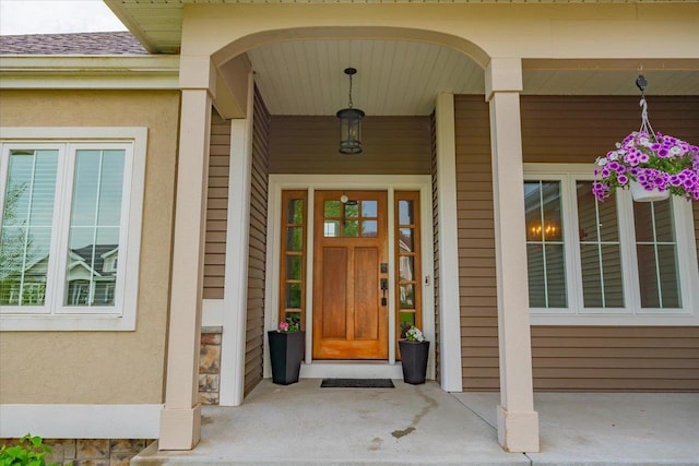1002 Millies Way, Waunakee, WI 53597 - view of exterior entry with a porch and stucco siding