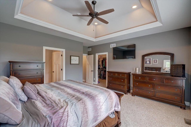 1002 Millies Way, Waunakee, WI 53597 - bedroom with a tray ceiling, light carpet, a walk in closet, ornamental molding, and a closet
