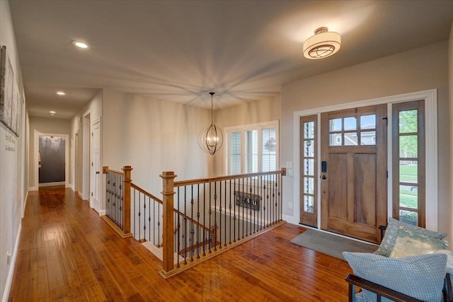 1002 Millies Way, Waunakee, WI 53597 - foyer entrance with hardwood / wood-style floors, recessed lighting, baseboards, plenty of natural light, and a chandelier