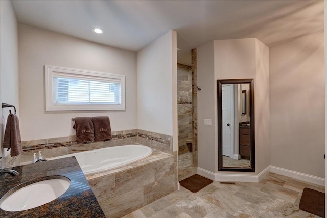 1002 Millies Way, Waunakee, WI 53597 - bathroom featuring a sink, tiled shower, and a garden tub