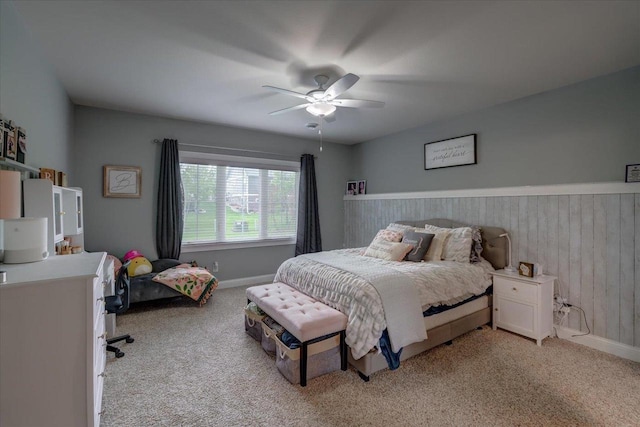 1002 Millies Way, Waunakee, WI 53597 - bedroom with light colored carpet, ceiling fan, wood walls, and baseboards