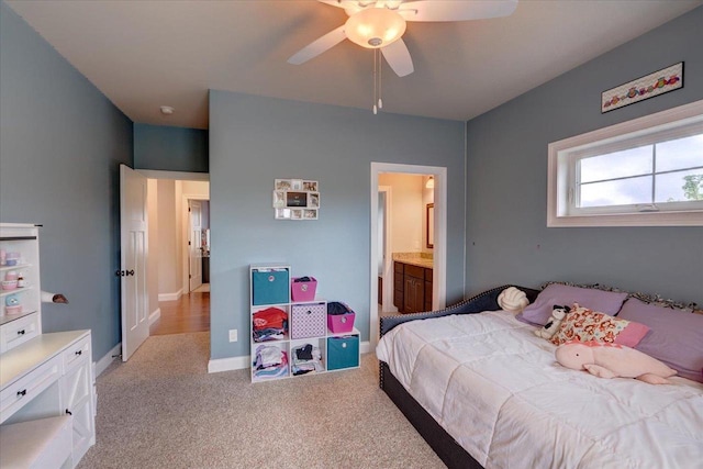1002 Millies Way, Waunakee, WI 53597 - carpeted bedroom with baseboards, connected bathroom, and a ceiling fan