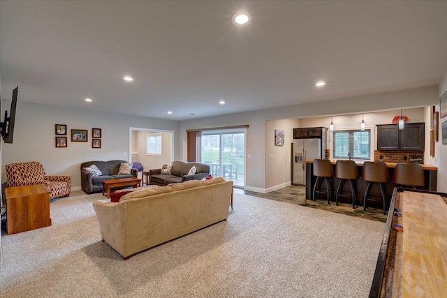 1002 Millies Way, Waunakee, WI 53597 - carpeted living area with recessed lighting, baseboards, and bar