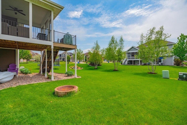 1002 Millies Way, Waunakee, WI 53597 - view of green lawn featuring stairs, a sunroom, a wooden deck, and ceiling fan