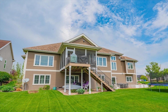 1002 Millies Way, Waunakee, WI 53597 - rear view of property with a trampoline, a sunroom, a yard, and stairway