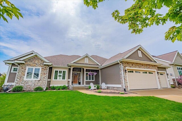 1002 Millies Way, Waunakee, WI 53597 - view of front of property featuring stone siding, a front lawn, a garage, and driveway