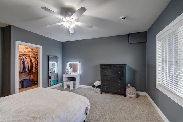 1002 Millies Way, Waunakee, WI 53597 - bedroom featuring carpet floors, a walk in closet, baseboards, and ceiling fan
