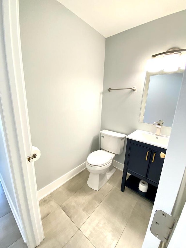 194 Vernon St, Williams Bay, WI 53191 - half bathroom featuring toilet, vanity, baseboards, and tile patterned floors