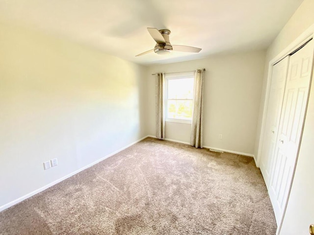 194 Vernon St, Williams Bay, WI 53191 - unfurnished bedroom featuring carpet floors, a closet, baseboards, and a ceiling fan