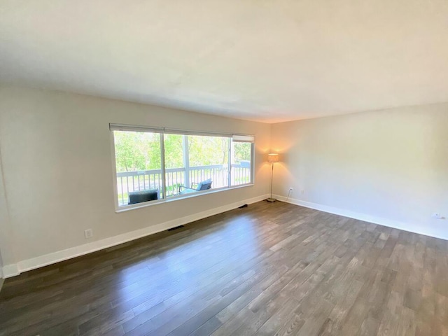 194 Vernon St, Williams Bay, WI 53191 - spare room featuring dark wood-type flooring and baseboards