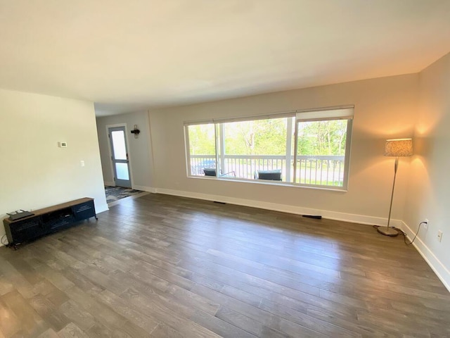 194 Vernon St, Williams Bay, WI 53191 - unfurnished living room featuring baseboards and dark wood-style flooring