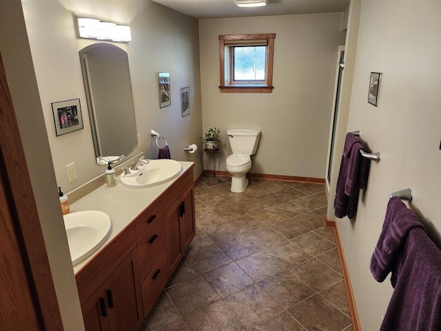 W7429 Akron Dr, Wild Rose, WI 54984 - full bathroom with toilet, double vanity, and baseboards
