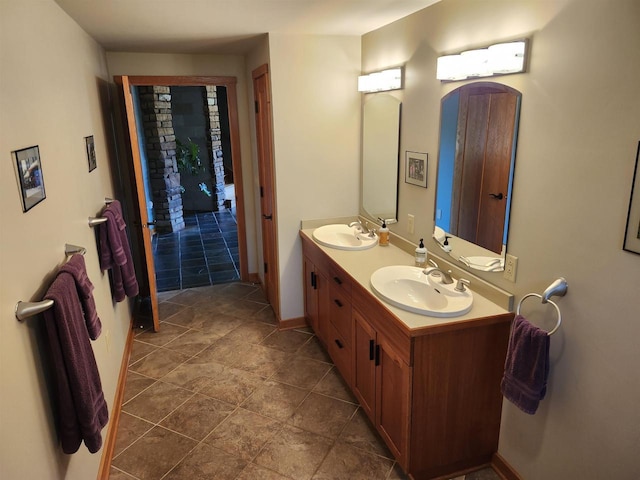 W7429 Akron Dr, Wild Rose, WI 54984 - bathroom featuring double vanity and baseboards