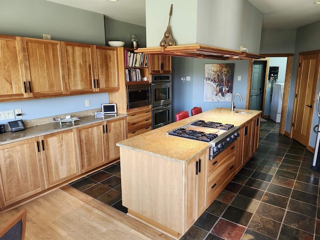 W7429 Akron Dr, Wild Rose, WI 54984 - kitchen featuring a sink, stainless steel gas stovetop, double wall oven, built in microwave, and an island with sink