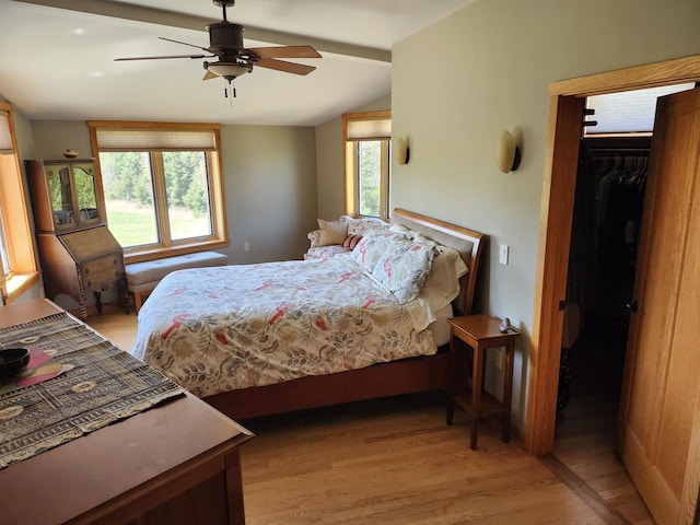 W7429 Akron Dr, Wild Rose, WI 54984 - bedroom featuring light wood-style flooring, lofted ceiling, a walk in closet, a closet, and a ceiling fan