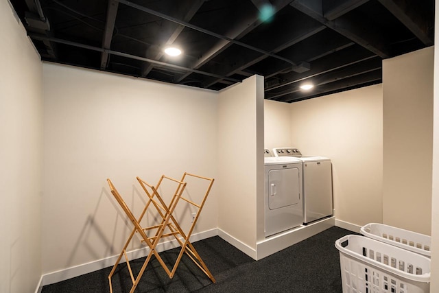 clothes washing area featuring washer and dryer, baseboards, and dark colored carpet