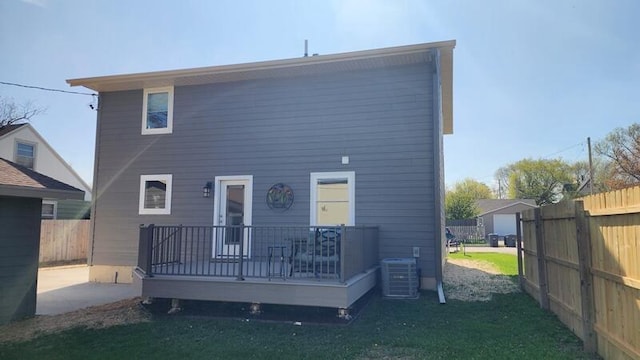 rear view of property with central air condition unit and a wooden deck