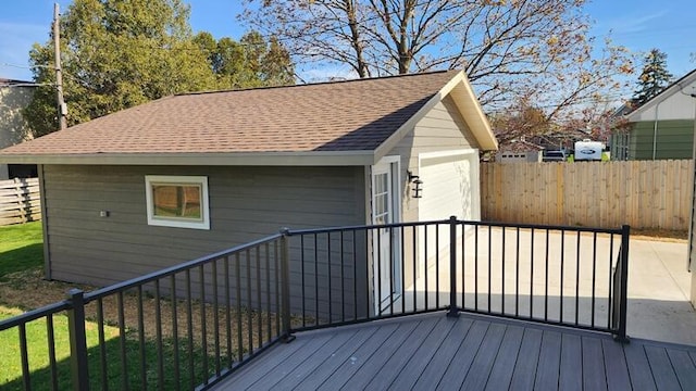 deck with fence and a garage