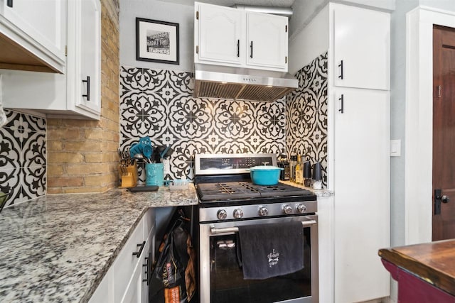 129 W 19th Ave, Oshkosh, WI 54902 - kitchen with stainless steel range with gas stovetop, under cabinet range hood, white cabinets, and tasteful backsplash