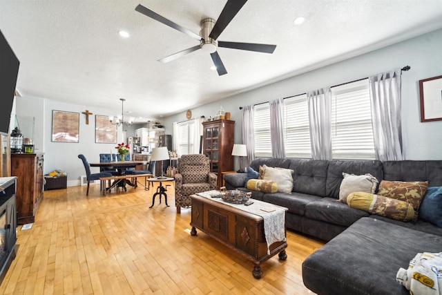 129 W 19th Ave, Oshkosh, WI 54902 - living area with a ceiling fan, healthy amount of natural light, a textured ceiling, light wood-type flooring, and a chandelier