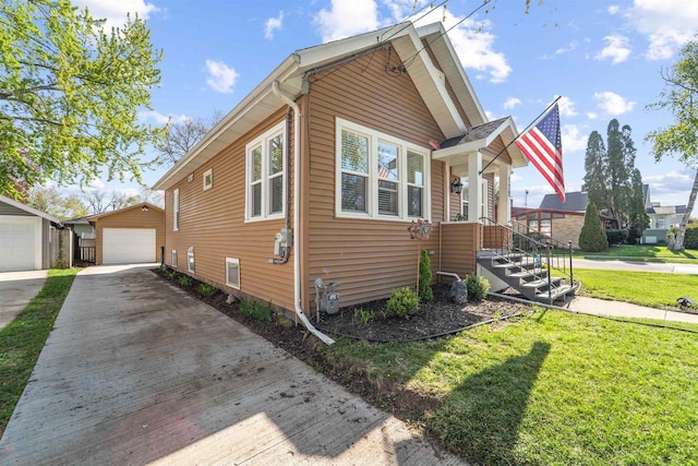 129 W 19th Ave, Oshkosh, WI 54902 - view of property exterior featuring concrete driveway, an outbuilding, a lawn, and a garage