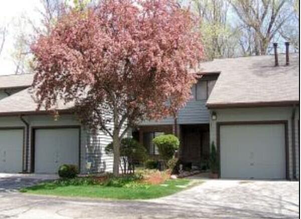 2734 Old Mill Dr Unit A-2, Racine, WI 53405 - obstructed view of property with an attached garage and driveway
