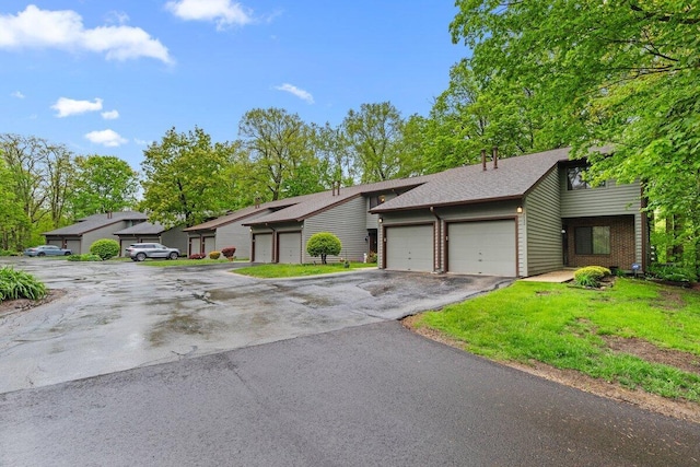 2734 Old Mill Dr Unit A-2, Racine, WI 53405 - view of front of house with asphalt driveway, a garage, roof with shingles, and brick siding