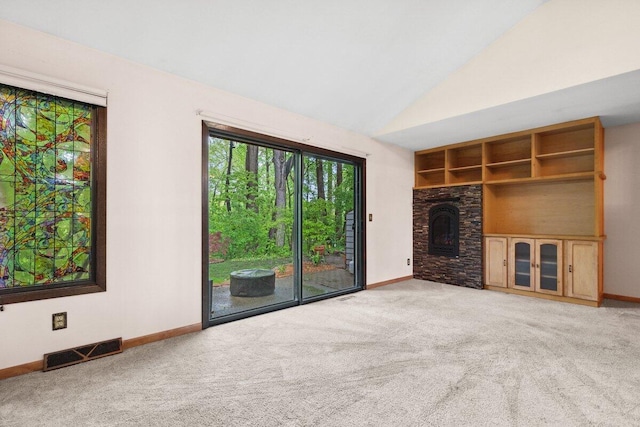2734 Old Mill Dr Unit A-2, Racine, WI 53405 - unfurnished living room with carpet floors, baseboards, a fireplace, and vaulted ceiling