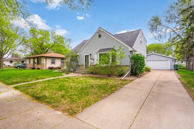 409 S Matthew St, Kimberly, WI 54136 - view of front of house with an outbuilding, a front yard, a garage, and brick siding
