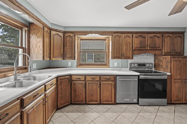 409 S Matthew St, Kimberly, WI 54136 - kitchen featuring stainless steel appliances, a sink, light countertops, and light tile patterned flooring