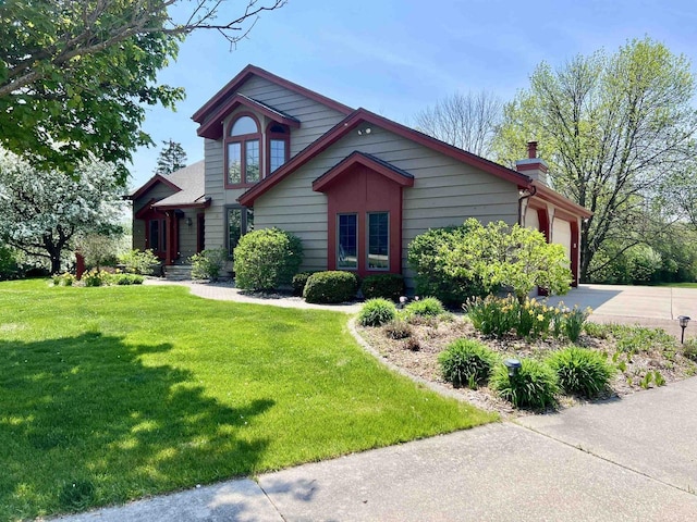 86 Ledgebrook Dr, Fond Du Lac, WI 54935 - view of front of house with driveway, a chimney, an attached garage, and a front lawn
