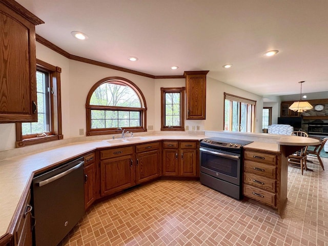 86 Ledgebrook Dr, Fond Du Lac, WI 54935 - kitchen with appliances with stainless steel finishes, a sink, a peninsula, light countertops, and brick patterned floors