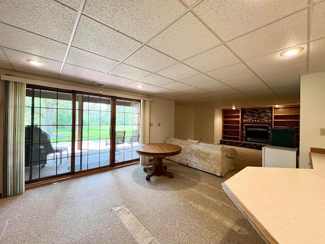 86 Ledgebrook Dr, Fond Du Lac, WI 54935 - living room featuring a brick fireplace, built in shelves, carpet, and a drop ceiling