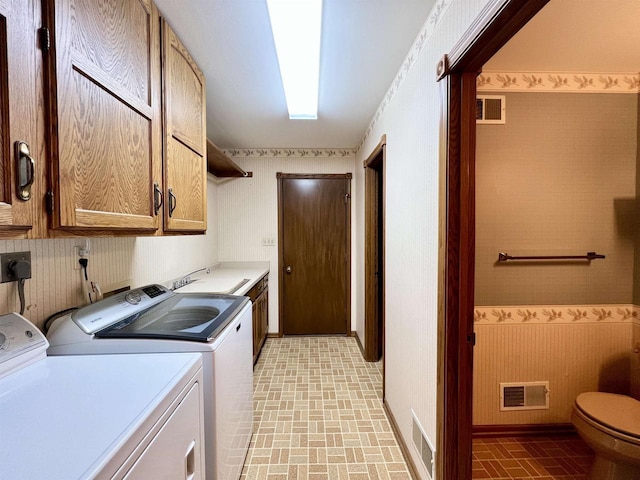 86 Ledgebrook Dr, Fond Du Lac, WI 54935 - laundry room with brick patterned flooring, washer and dryer, and cabinet space