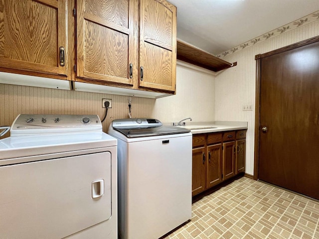 86 Ledgebrook Dr, Fond Du Lac, WI 54935 - laundry room with wallpapered walls, brick patterned floors, washing machine and dryer, and cabinet space